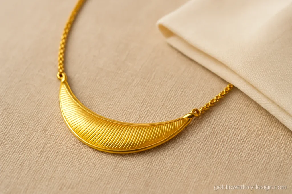Light weight gold necklace design with a hollow crescent front and fine rope chain