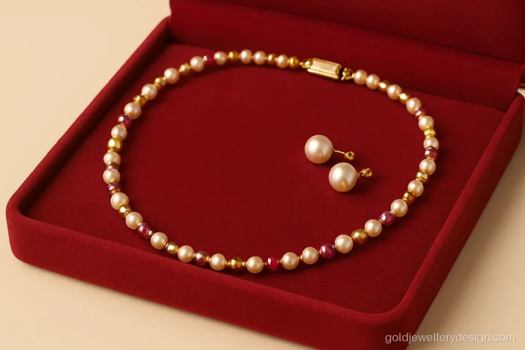 Short gold necklace with alternating pearls, rubies and gold beads in a jewellery box