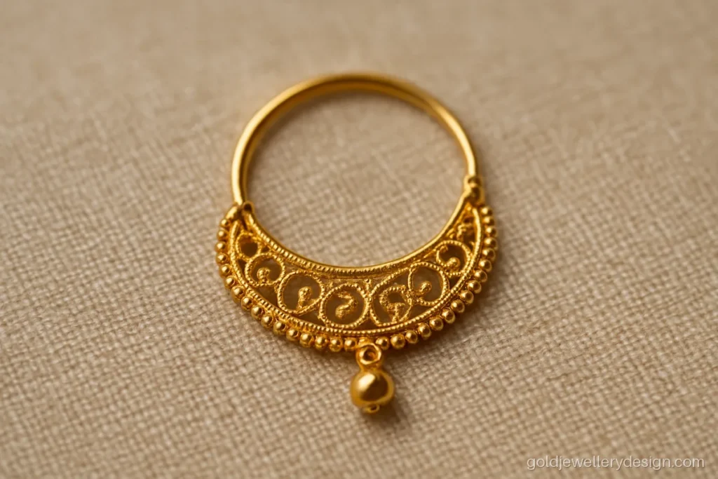 Bengali style gold nose ring with a fine filigree half moon and a bead drop