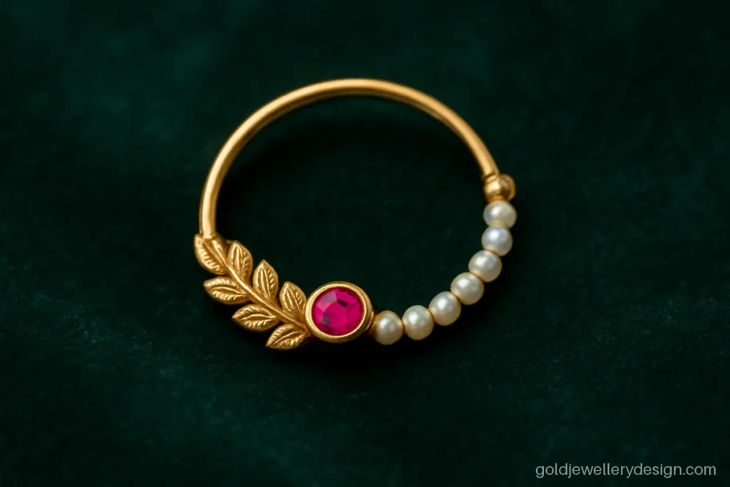 Bridal gold nose ring design with a seed pearl string and fine leaf work