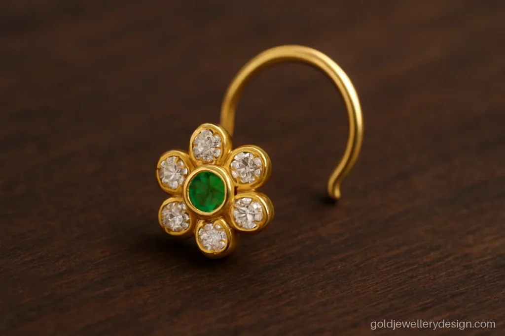 Flower cluster gold nose pin with a green emerald centre and white stone petals