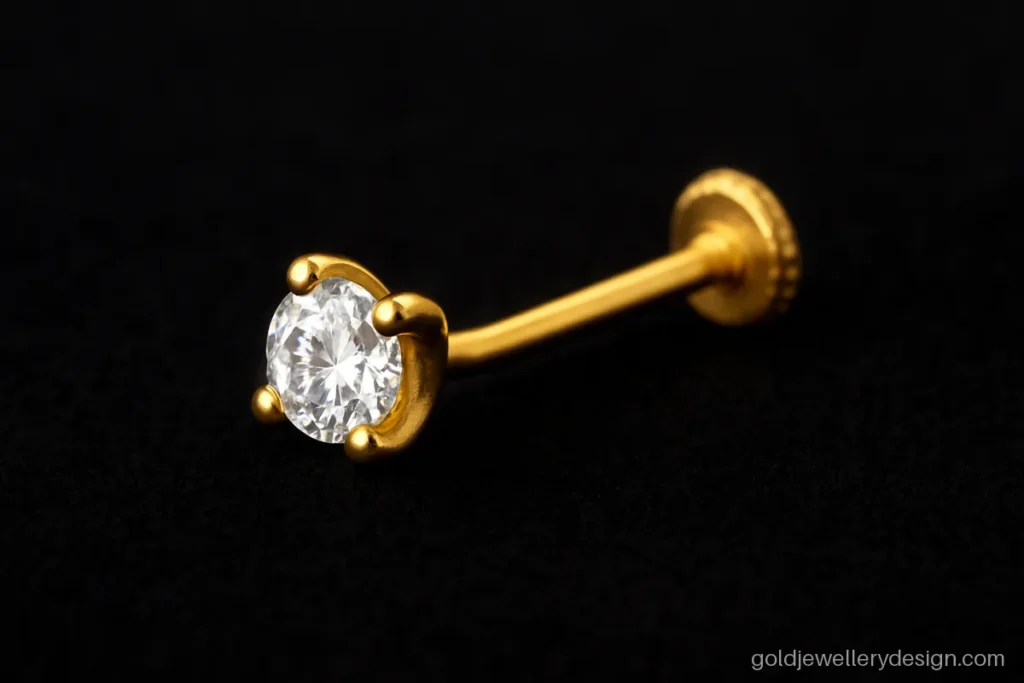 Single CZ nose pin gold design held in four small gold prongs