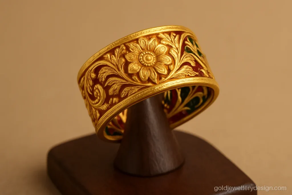 Jodha ring gold design with a carved front and a red and green enamel back