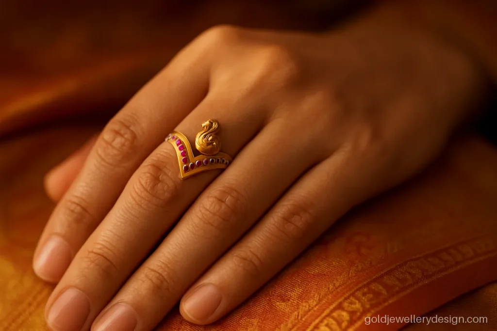 Vanki ring gold design with a V shape, rubies and a small peacock top