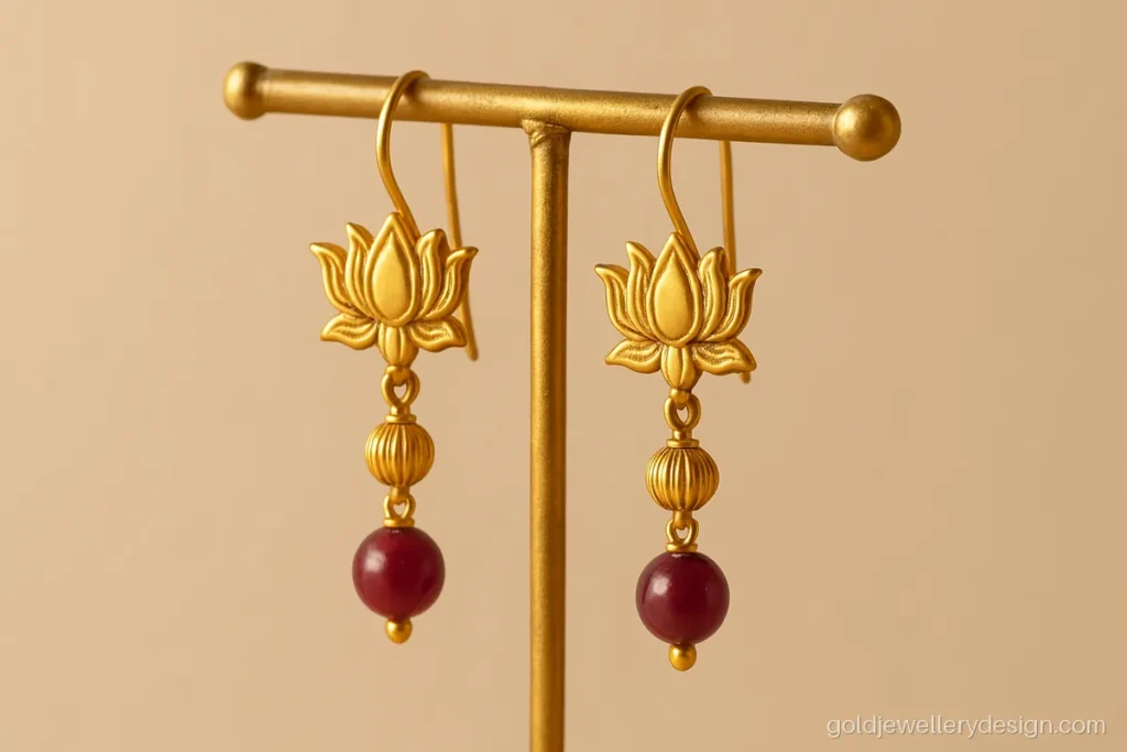 Sui dhaga design gold latkan with a lotus top and a ruby bead drop