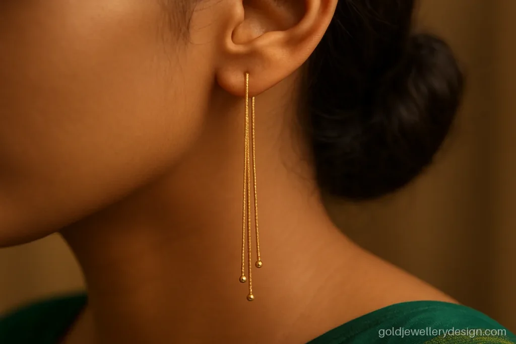 Gold long earrings design with three chains of graduated length