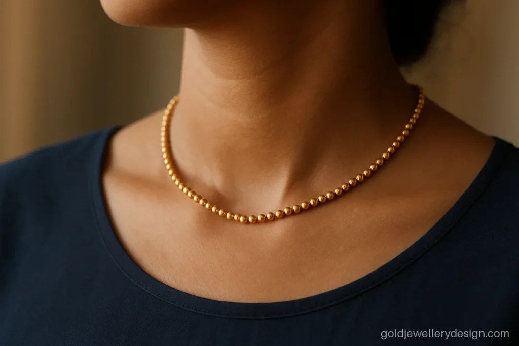 Eight gram gold bead choker worn close to the neck with a plain blouse