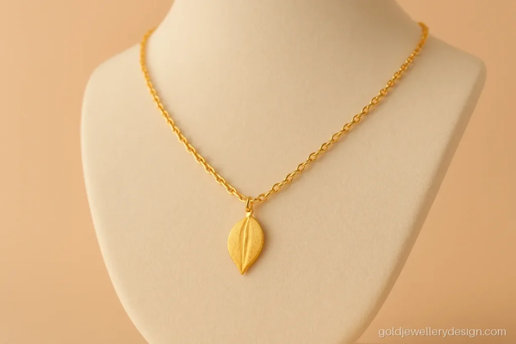 Six gram gold necklace with a small leaf pendant fixed on a cable chain