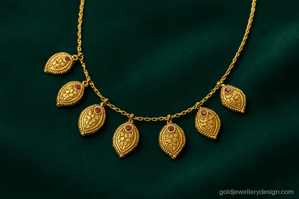 Gold necklace design 10 gram with small mango motifs linked on a fine chain