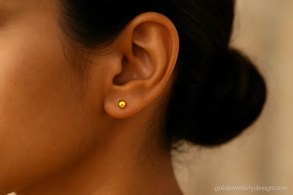 Small polished gold ball studs about 1 gram for the pair, worn on the lobe