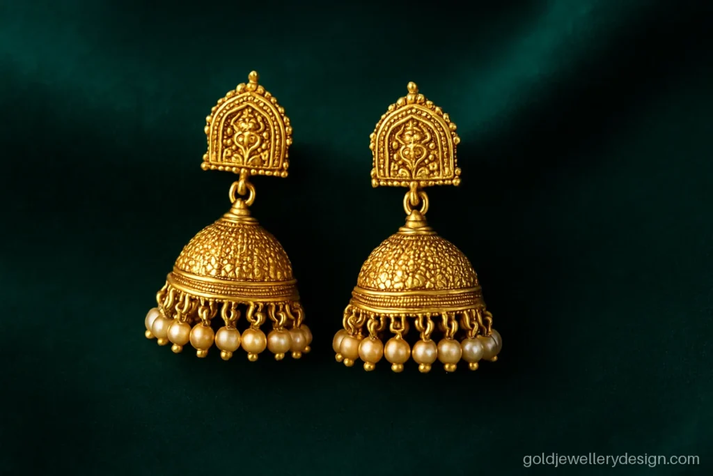 5 gram gold earrings jhumka design with a temple arch top and pearl fringe